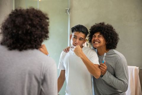 Diverse Friends Embracing Morning Routine in Modern Bathroom