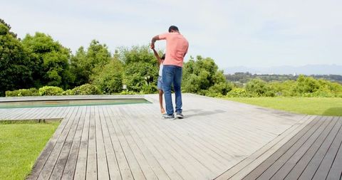 Father and Daughter Creating Cherished Memories on Garden Deck