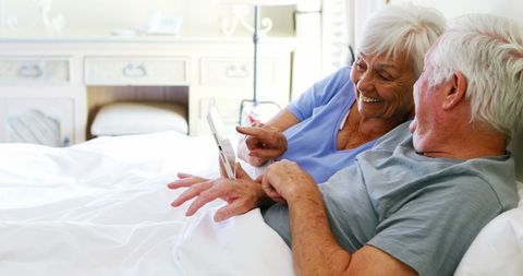 Senior Couple Enjoying Tablet Time in Cozy Bedroom - Download Free Stock Images Pikwizard.com