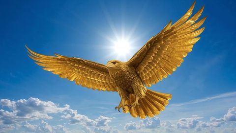 Soaring Golden Eagle Sculpture Gliding Through Sun Halo Over Blue Sky and Clouds