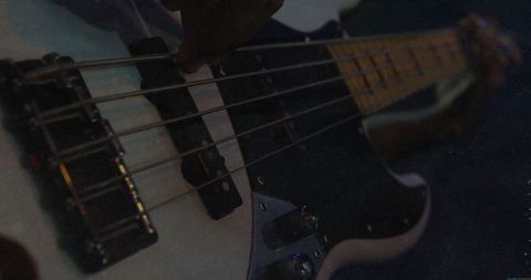 Dimly lit studio bass guitar session