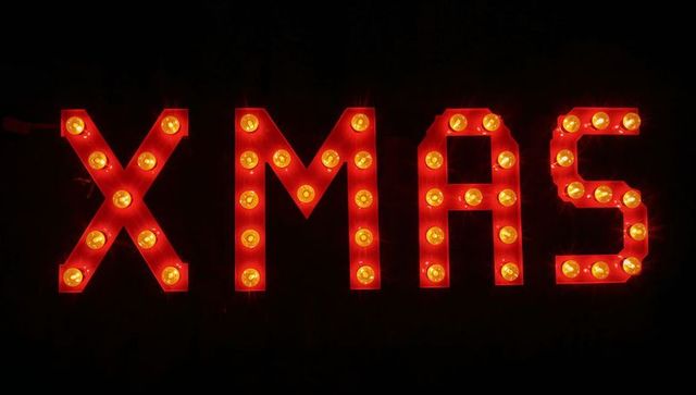 Retro marquee xmas lights with warm bulbs on dark background for holiday signage decor
