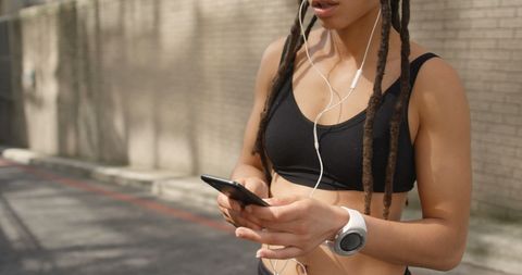 Fashionable Woman Using Phone Outdoors Listening to Music - Download Free Stock Images Pikwizard.com