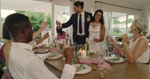 Bride and Groom Toasting at Elegant Indoor Wedding Reception