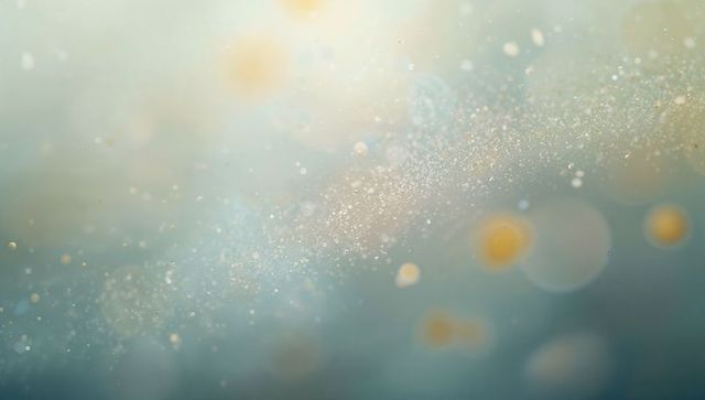 Teal and gold glitter cloud drifting diagonally with soft bokeh halo lights and shimmer