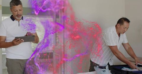 Middle-aged men packing suitcase using tablet with purple digital mist travel concept