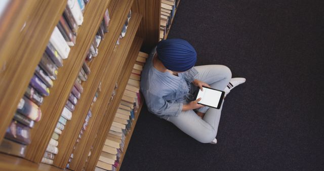 Woman in Library Sitting on Floor Reading Digital Tablet - Download Free Stock Images Pikwizard.com