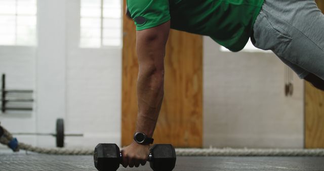 Man Engaging in Dumbbell Push-Up Workout in Modern Gym - Download Free Stock Images Pikwizard.com