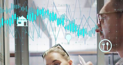 Colleagues Analyzing Business Growth Data with Digital Graphs