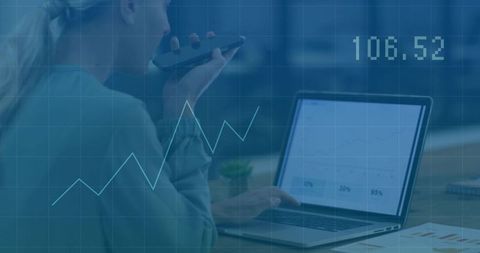 Businesswoman using phone and laptop analyzing financial trends