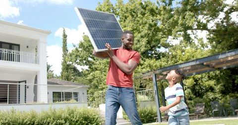 Father and son exploring renewable energy with solar panel