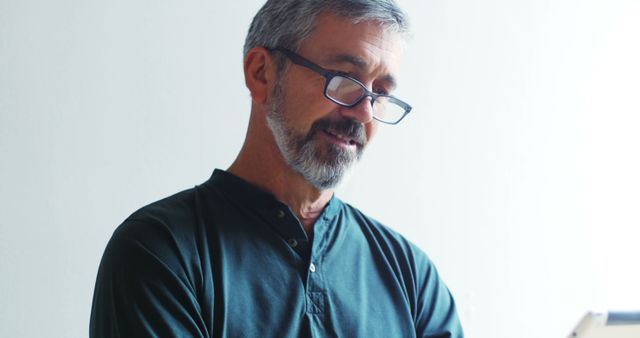 Smiling Older Man Wearing Glasses Reading a Book Indoors - Download Free Stock Images Pikwizard.com