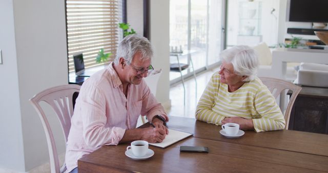 Senior caucasian couple talking to each other calculating finances together at home. retirement senior couple lifestyle living