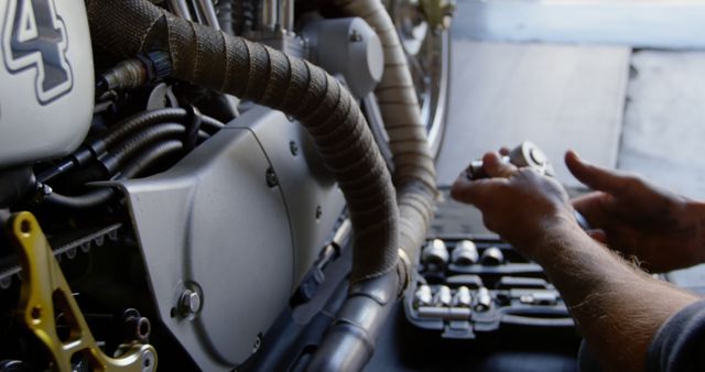 Mechanic Working on Motorcycle Engine Using Tools - Download Free Stock Images Pikwizard.com