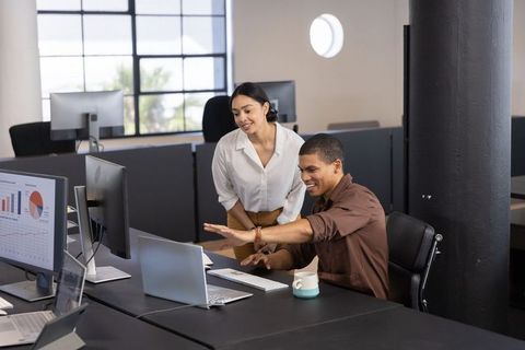 Colleagues Collaborating in Modern Workspace, Analyzing Data Charts