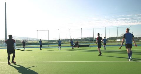 Male Field Hockey Teammates Practicing on Urban Turf