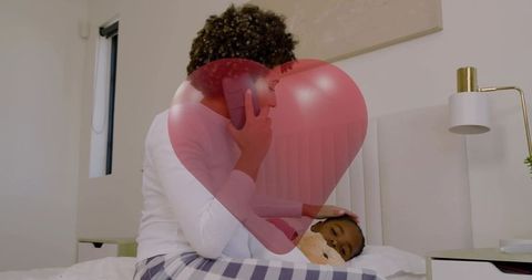 Talking on phone while comforting child in bed nighttime parenting tender care
