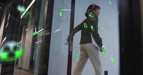 Businesswoman Walking through Office with Futuristic AR Icons