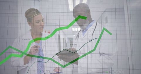 Doctors Analyzing Data with Graph Overlay in Hospital Corridor