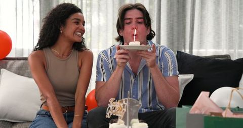 Couple Celebrating Birthday with Cupcake and Candle