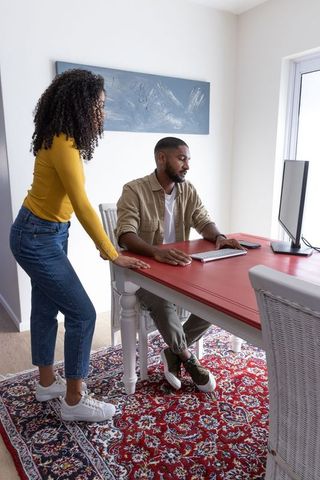 Diverse Couple Collaborating at Home Office Desk