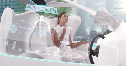 Woman in futuristic self-driving car with digital display