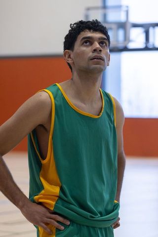 Focused Basketball Player in Gym Gazing at Hoop