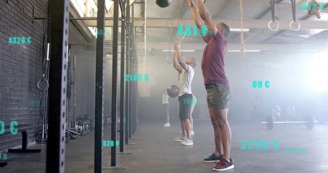 Men practicing crossfit with metrics in urban gym