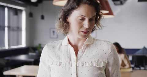 Confident Businesswoman Navigating Tablet Technology in Modern Office