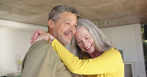 Senior Couple Embracing in Kitchen with Loving Warmth