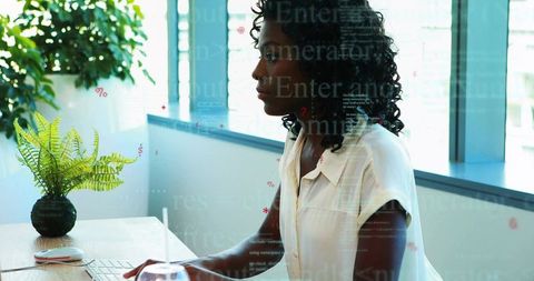 Woman focused at work desk in bright office interior
