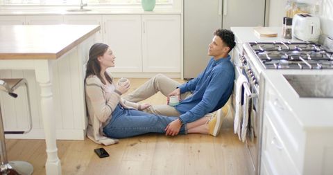 Happy Couple Enjoys Coffee and Conversation in Kitchen