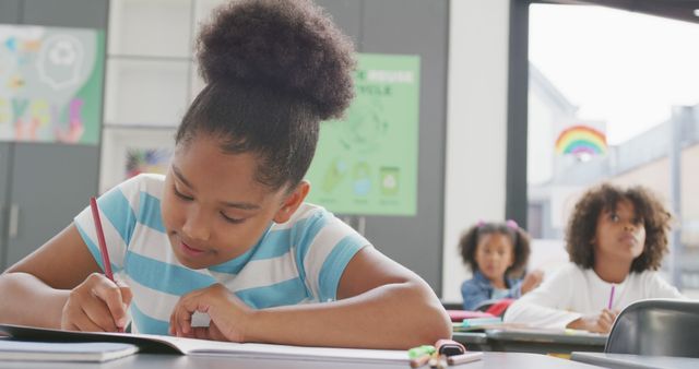 Young African American Student Focused on Schoolwork in Classroom - Download Free Stock Images Pikwizard.com