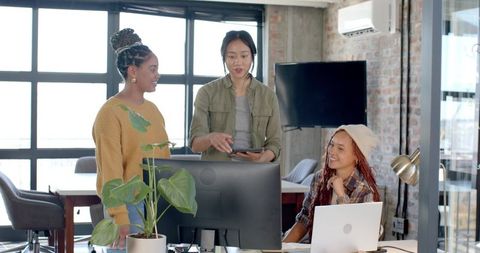 Team Collaborating at Loft Desk in Modern Office Setting