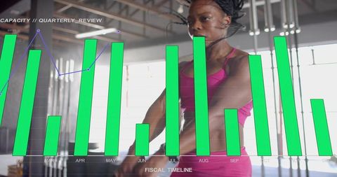 Athlete pulling battle ropes with fitness data overlay showing monthly performance metrics