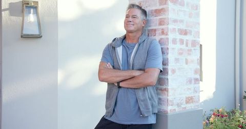 Relaxed middle-aged man enjoying outdoor patio leisurely