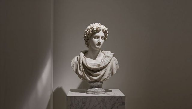 Marble bust of classical figure in museum gallery