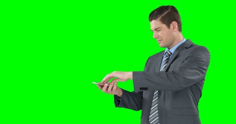 Businessman Engaging with Smartphone on Bright Green Screen - Download Free Stock Images Pikwizard.com