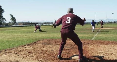 Baseball Coach in Action on Sports Field Promoting Teamwork