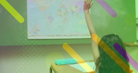 Student raising hand in classroom with world map, colorful translucent overlay for education