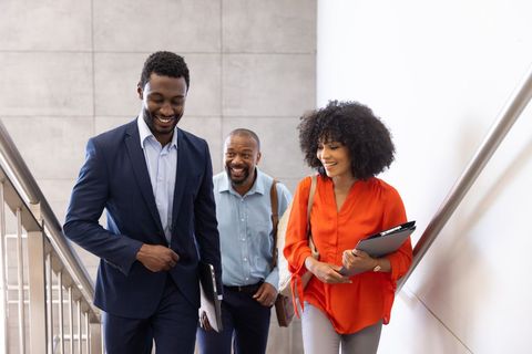 Professional Team Collaborating in Office Stairwell