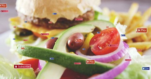 Closeup avocado salad featuring cheeseburger, fries and social media badges for food video concept