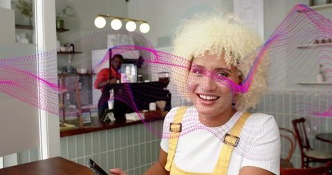 Smiling Woman in Cafe Sitting with Smartphone and Abstract Wave