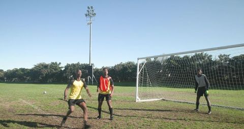 Soccer Training with African American Players on Field Near Goal