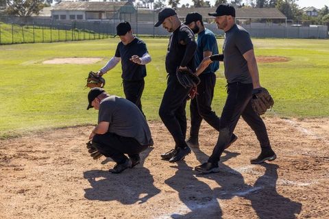 Recreational Baseball Teammates Gathering on Infield Practicing Fielding and Teamwork