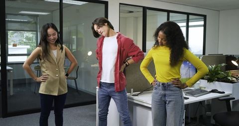 Coworkers perform ergonomic stretches in open-plan office