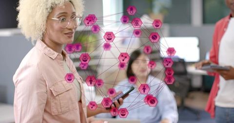 Curly-haired professional leading digital collaboration with mobile and tablet in modern office