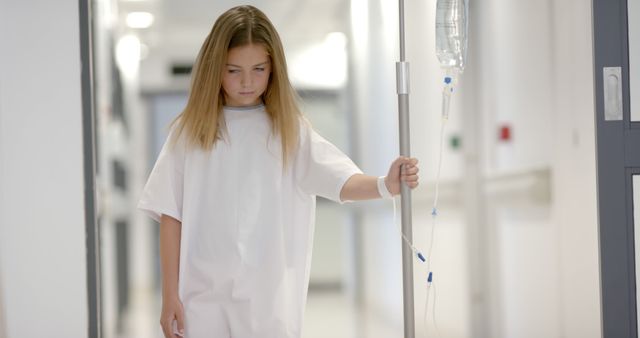 Young girl recovering in hospital, walking with IV pole - Download Free Stock Images Pikwizard.com