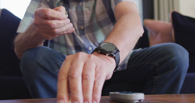 Senior Man Testing Blood Sugar with Glucometer Sitting on Couch - Download Free Stock Images Pikwizard.com