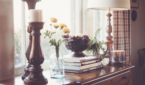 Elegant vintage decor on wooden cabinet with book by window light